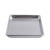 A rectangular, shallow 1/4 size sheet pan with raised edges is shown from a slight angle against a plain white background. The tray has a smooth, reflective surface and rounded corners, appearing clean and empty.