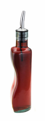 A curved green glass bottle filled with red liquid, likely vinegar or oil, features a stainless steel pourer and is isolated on a white background.
