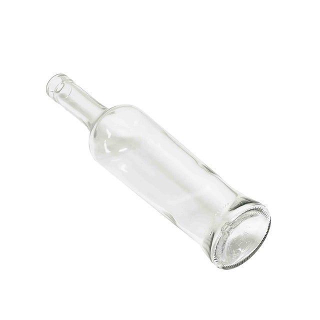 A clear 16 oz glass oil & vinegar bottle is positioned diagonally on a white background, featuring a long neck, wide base, and smooth surface with light reflections. The circular base and thick glass edge face forward.