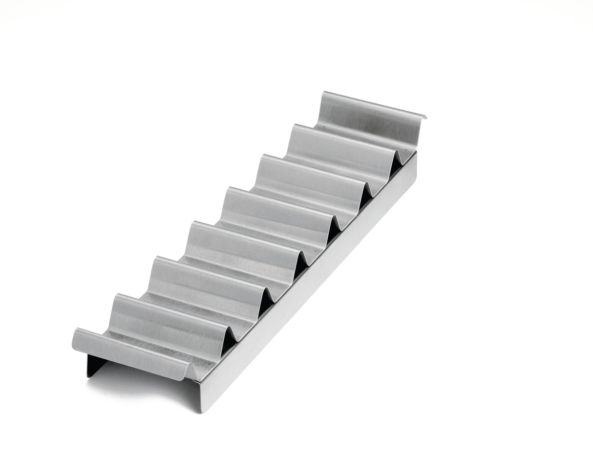A metal taco holder with six wave-shaped slots sits on a white background. The shiny, stainless steel taco prep tray keeps tacos upright and separated, and is also dishwasher safe for easy cleaning.