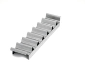 A metal taco holder with six wave-shaped slots sits on a white background. The shiny, stainless steel taco prep tray keeps tacos upright and separated, and is also dishwasher safe for easy cleaning.