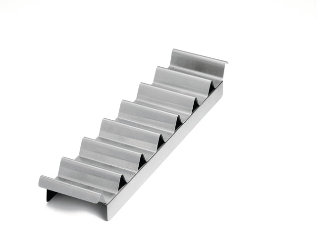 A metal taco holder with six wave-shaped slots sits on a white background. The shiny, stainless steel taco prep tray keeps tacos upright and separated, and is also dishwasher safe for easy cleaning.