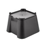 A black, square-shaped plastic riser with slightly flared sides and rounded corners, designed as a replacement base for beverage dispensers. It features a flat top with a small central indentation and low notched edges, sitting on a white background.