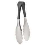A pair of small, dishwasher safe metal tongs with scalloped stainless steel edges and a black, slightly curved handle. The tongs are closed and upright, with the handle at the top and gripping ends pointed downward.