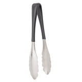 A pair of dishwasher safe kitchen tongs with black handles and scalloped stainless steel gripping ends stands upright against a white background. The tongs are slightly open, displaying their functional design for gripping and serving food.
