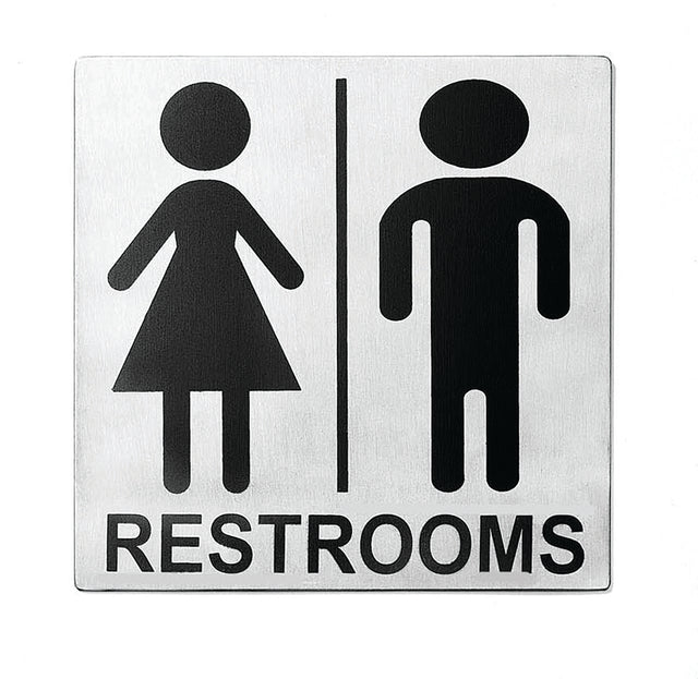 A stainless steel restroom sign with black icons: a figure in a dress on the left and one in pants on the right, divided by a vertical line. RESTROOMS is printed below in bold uppercase letters. Features pressure sensitive adhesive for easy mounting.