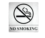 A stainless steel No Smoking sign features a bold black no smoking symbol—a lit cigarette crossed out—above NO SMOKING in large letters on a white background, with pressure sensitive adhesive for easy mounting.