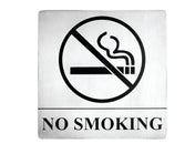 A stainless steel No Smoking sign features a bold black no smoking symbol—a lit cigarette crossed out—above NO SMOKING in large letters on a white background, with pressure sensitive adhesive for easy mounting.