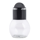 A clear, round glass Hottle container with a ribbed, black plastic screw-on lid and a smooth, dome-shaped top. The jar is empty, dishwasher safe, and shown against a white background.