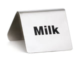 A small, tent-shaped buffet tent made of stainless steel with the word "Milk" printed in bold black letters on one side, photographed against a plain white background.