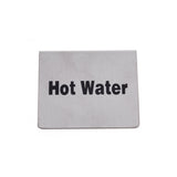 A rectangular stainless steel sign with the words Hot Water printed in bold black letters on a plain, brushed silver background. The sign is simple, with no decorations, and photographed against a white backdrop—ideal for a buffet tent setup.