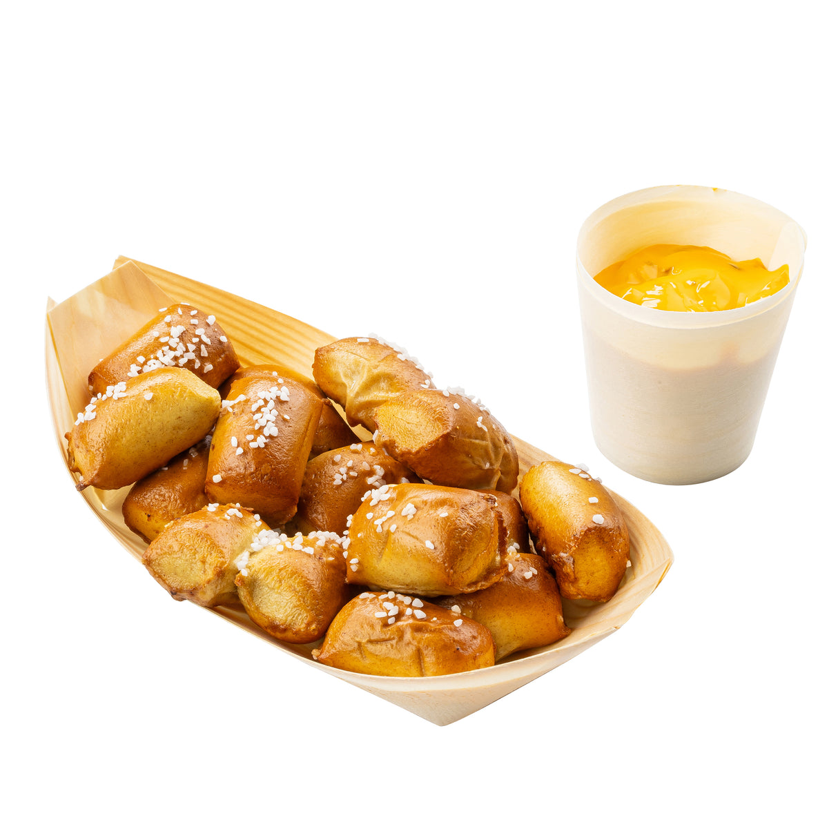 A wooden tray, such as a biodegradable pinewood boat like the TableCraft BAMDB5, is filled with bite-sized, golden-brown pretzel nuggets topped with coarse salt beside a small white cup of creamy yellow cheese sauce. The plain white background highlights the snack.