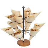 A tiered black metal stand with a wooden base holds several eco-friendly, disposable serving cones, each filled with mixed nuts. The light-colored cones are arranged in a circular pattern on different levels of the stand.