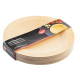A stack of round, light tan TableCraft disposable bamboo plates is shown partially wrapped in branded packaging. The label features photos of food and the product name in English, French, and Spanish. Each 11 inch plate has a smooth finish and natural wood grain.