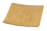 A small, square, shallow disposable dish made of light-colored bamboo with a natural wood grain texture. The edges are slightly curved upward and the surface is smooth. The empty TableCraft plate is photographed against a white background.