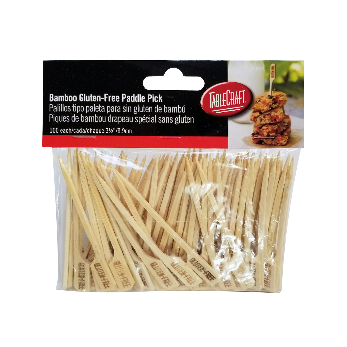 A clear plastic package of TableCraft bamboo picks, containing 100 gluten-free picks. The light-colored bamboo pick has a flat paddle end marked “Gluten Free.” The package features a food photo and product details in English, Spanish, and French.