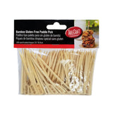 A clear plastic package of TableCraft bamboo picks, containing 100 gluten-free picks. The light-colored bamboo pick has a flat paddle end marked “Gluten Free.” The package features a food photo and product details in English, Spanish, and French.