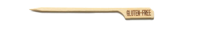 A single TableCraft bamboo pick shaped like a guitar, with the words GLUTEN-FREE engraved on the flat part of the pick. The background is plain white.