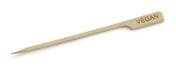 A Bamboo Pick with a pointed end and a flat handle, engraved with VEGAN to label plant-based dishes at events. Ideal for Cash & Carry, this Vegan Pick clearly identifies vegan food items against a white background.