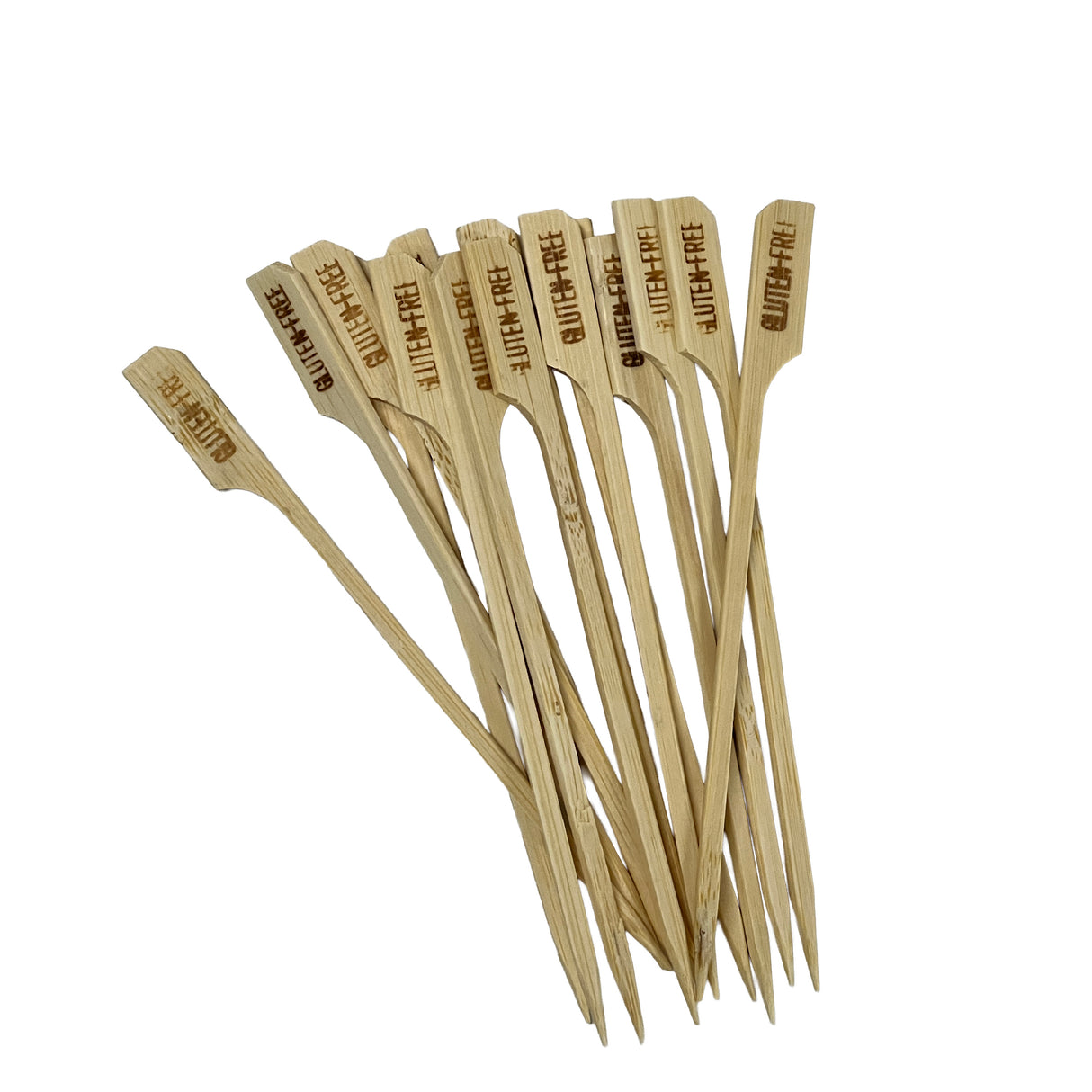 A group of TableCraft Products bamboo picks with flat, paddle-shaped tops lies on a white background. The tops are stamped “GLUTEN-FREE” in bold letters, clearly identifying each as a Gluten-Free Pick for safe food options.