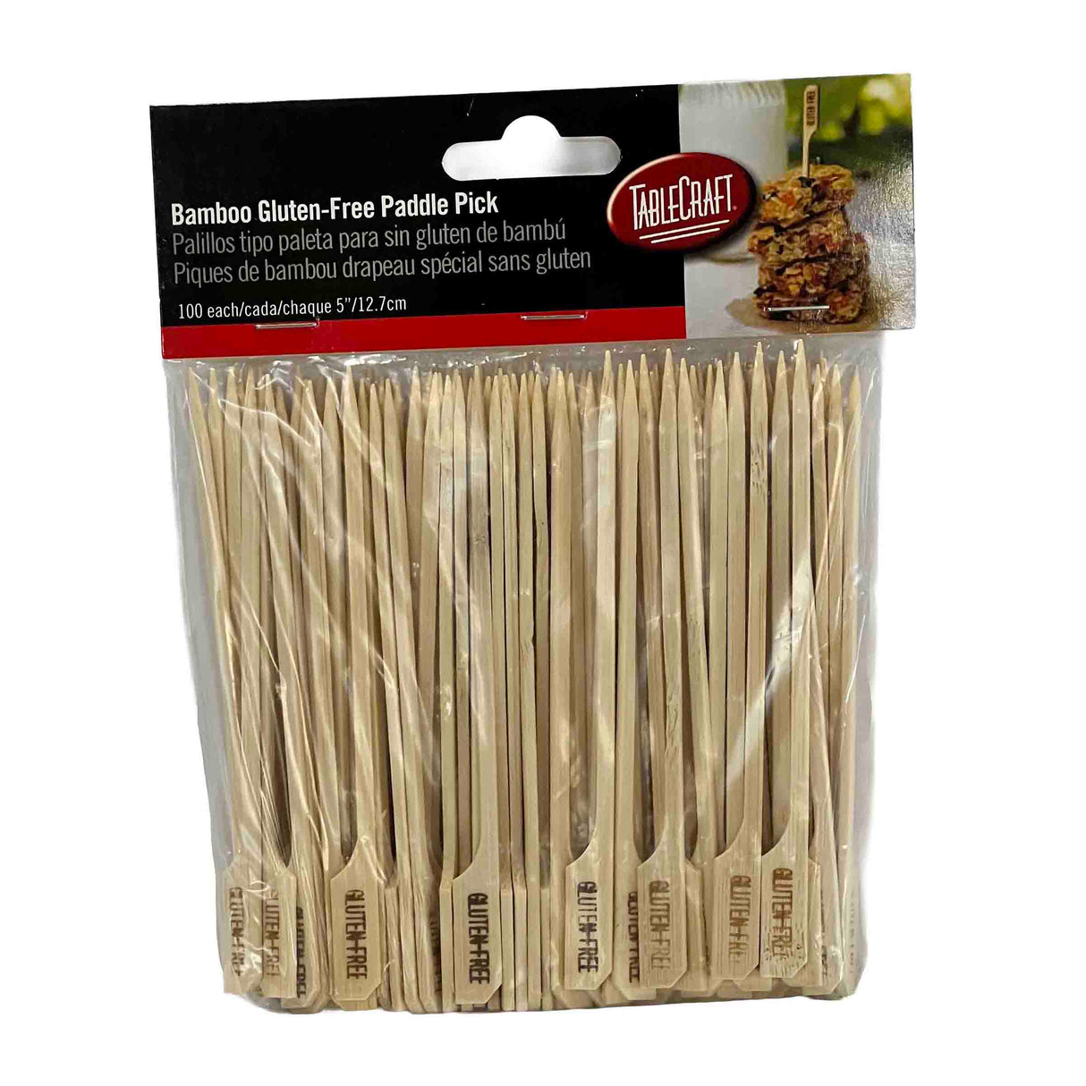 A package of TableCraft Products Bamboo Gluten-Free Paddle Picks. The clear bag holds 100 bamboo picks, each 5 1/2 inches long with a flat end labeled GLUTEN FREE. The red and white label features grilled food imagery. Perfect as a gluten-free pick option.