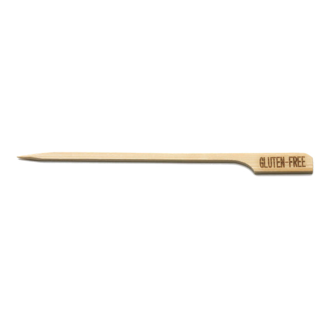 A single bamboo pick with a pointed end and flat handle, stamped “GLUTEN-FREE” in brown capital letters. This TableCraft Products Gluten-Free Pick is set against a plain white background.
