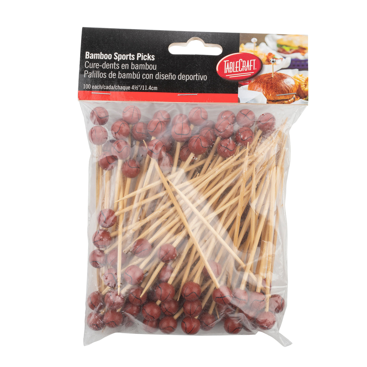 A clear plastic bag of bamboo Sport Picks, each topped with a miniature brown basketball. The label reads Bamboo Sports Picks and includes 100 count in English, Spanish, and French. A TableCraft logo appears in the top right corner.