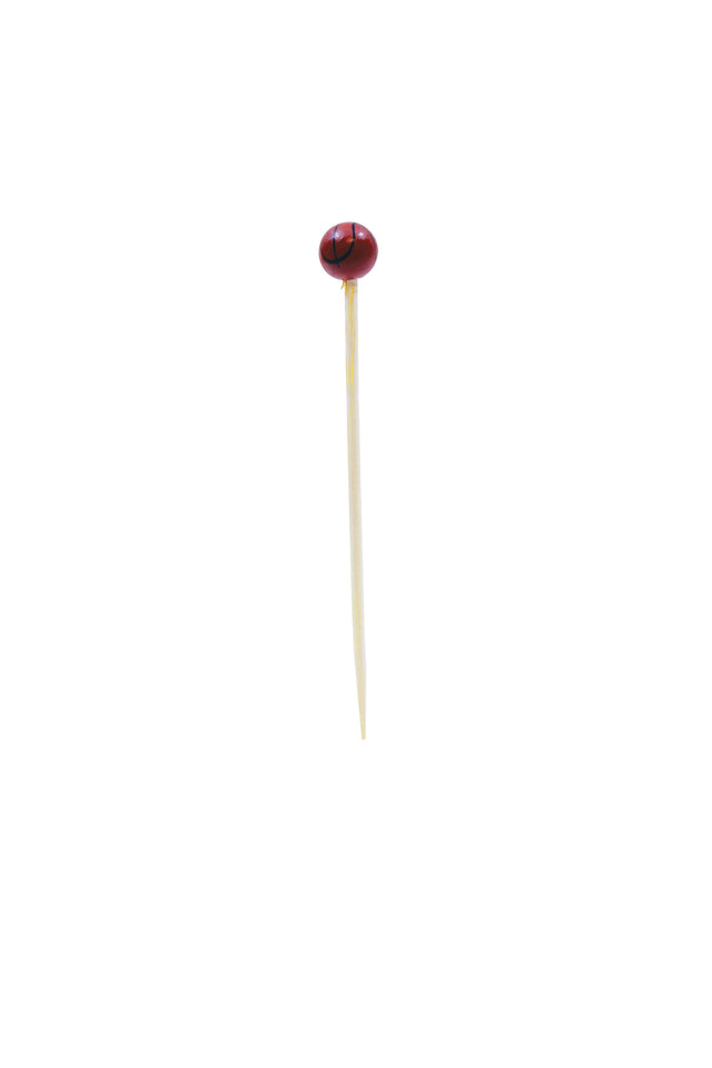 A bamboo sport pick with a dark red, round bead featuring a black line detail on top. The toothpick stands upright against a plain white background, with the bead resembling a small olive or basketball decoration.