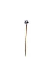 A single bamboo toothpick stands upright on a white background, its top adorned with a small, round decoration resembling a classic black and white soccer ball—a perfect sport pick for themed gatherings.