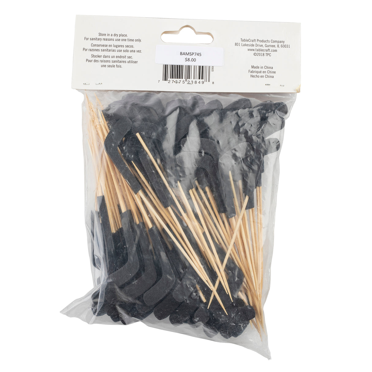 A clear plastic bag contains several black felt mustache cutouts attached to bamboo sticks. A beige label with a barcode and product details is stapled to the bag’s top, including storage instructions and the price, $6.00.
