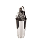 A stainless steel cocktail kit holds three essential bar tools: a coiled strainer, bottle opener, and citrus squeezer. The shiny set stands upright on a white background with clear reflections on its polished surfaces.