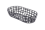 A black powder coated metal serving basket from the Complexity Collection, featuring an oval shape and open grid design with evenly spaced horizontal and vertical strips. It sits on a white background, viewed from a slight angle above.