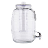 The TableCraft Beehive Beverage Dispenser features clear, ribbed glass with a metal spigot and glass lid. Inside, a removable ice core keeps drinks cool. A metal chain with a blank round tag hangs from the lid. Shown empty against a white background.