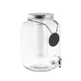 A clear 2 gallon Mason Jar Beverage Dispenser with a silver screw-on lid, cylindrical infuser, and silver spigot. A black tag hangs from the lid chain, ready for labeling. The glass dispenser is empty and set against a white background.