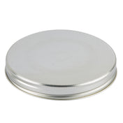 A round, flat silver metal Replacement Top with a smooth top and a textured, ridged edge. Ideal for a Mason Jar Beverage Dispenser, the lid appears unused and clean against a white background. It is also dishwasher safe for easy cleaning.