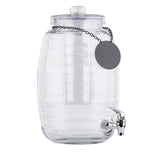 A clear glass beverage dispenser with a ribbed design features a matching lid, silver spigot, and chain with a blank round label. Inside is a tall, cylindrical infuser tube—perfect for flavoring drinks. This dispenser is dishwasher safe for easy cleaning.