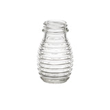 A clear, empty TableCraft glass jar with a wide opening and a ribbed, beehive-like design is centered on a white background. The smooth, transparent glass highlights the horizontal ridges, perfect as a replacement shaker or salt and pepper shaker.