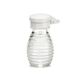 A small, clear, ribbed glass syrup dispenser with a white plastic flip-top lid is shown against a plain white background. The bottle is empty, stands upright, and is dishwasher safe for easy cleaning.