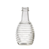 A clear, empty 6 oz glass bottle with a ribbed, beehive-like design, tapered shoulders, and a short neck. Ideal as a replacement jar for oil/vinegar, it stands upright on a white background with no cap or label.