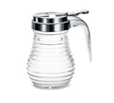 A clear, ribbed glass Syrup dispenser from the Beehive Collection by TableCraft, featuring a shiny metal lid with a lever for pouring and a small circular opening. The empty dispenser is photographed against a plain white background.