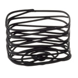 A stack of black rubber bands, reminiscent of an Artisan Collection sugar packet holder, is arranged haphazardly in a loose cube shape against a white background. The bands overlap and twist, forming an open and irregular three-dimensional structure.