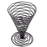 A black powder coated metal wire basket shaped like a wide-mouthed, tapered cone with an open spiral design stands upright on a flat spiral base. From TableCraft’s Artisan Collection Appetizer Cone, its evenly spaced coils create a geometric, airy structure.