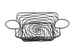 A square black powder coated metal wire basket with swirling, spiral patterns at the base and sides, part of the Artisan Collection Basket. It features two large, round handles on opposite sides. The background is plain white.