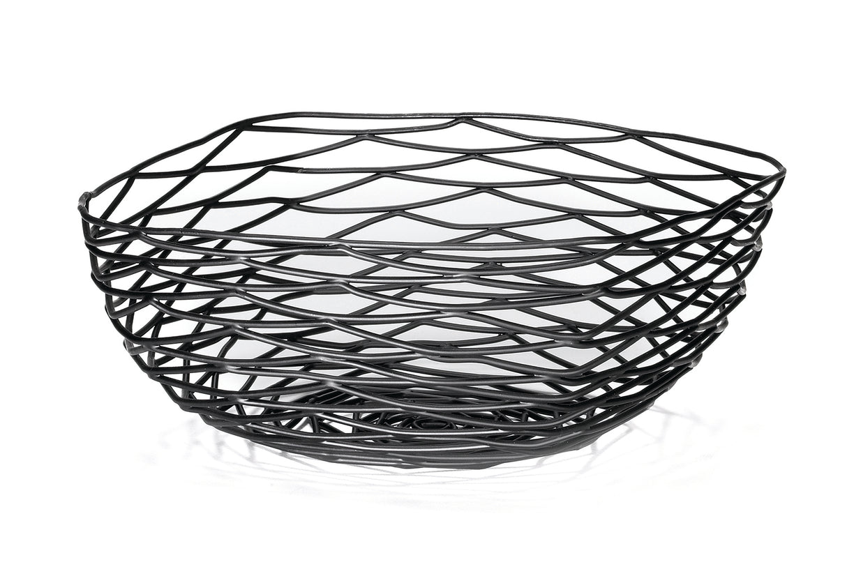 A black powder coated metal basket with an open, geometric design featuring wavy, crisscrossing lines. This Artisan Collection Basket by TableCraft BK17310 has an irregular shape and casts unique patterned shadows on the white surface below.