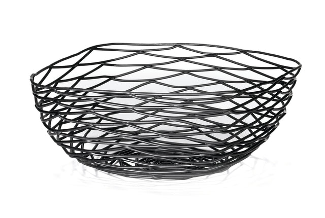 A black powder coated metal basket with an open, geometric design featuring wavy, crisscrossing lines. This Artisan Collection Basket by TableCraft BK17310 has an irregular shape and casts unique patterned shadows on the white surface below.
