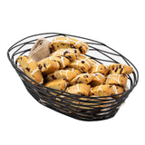 A black powder coated metal basket from the Artisan Collection Basket by TableCraft Products holds golden brown biscotti with dried fruit, each piece drizzled in a crisscross of white icing and nestled in a beige cloth.