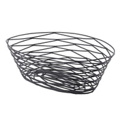 A modern oval Artisan Collection Basket, crafted from black powder coated metal. Its open, crisscrossing pattern and irregularly angled lines create a geometric, airy look. This TableCraft BK17410 basket sits flat with no handles for a sleek finish.