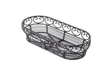 An empty, black, oval-shaped wire basket from the TableCraft Mediterranean Collection Basket line features decorative swirls along the upper edge. Crafted from black powder coated metal, its airy design is photographed on a white background.