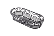An empty, black, oval-shaped wire basket from the TableCraft Mediterranean Collection Basket line features decorative swirls along the upper edge. Crafted from black powder coated metal, its airy design is photographed on a white background.