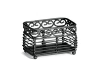 A rectangular, black metal basket from the Mediterranean Collection by TableCraft, featuring decorative swirl patterns. This sturdy Sugar Packet Holder has an open, slatted design with small round feet and is photographed on a white background.